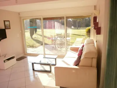 a living room with a couch and a glass table at Pervenches in Jonquerettes