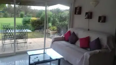 a living room with a couch and a view of a patio at Pervenches in Jonquerettes
