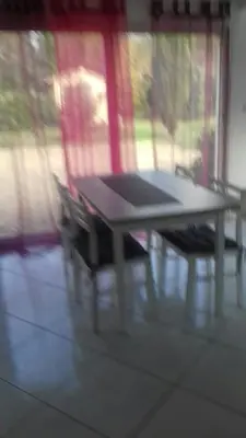 a table and two chairs in front of a window at Pervenches in Jonquerettes