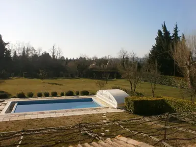 a swimming pool in a yard with a garden at Pervenches in Jonquerettes