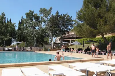 a group of people in the swimming pool at a resort at La Bastide de Venelles in Venelles