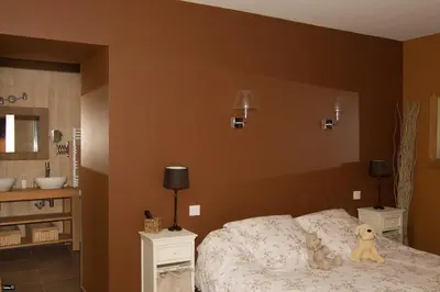a bedroom with a bed with a teddy bear on it at La Bastide de Venelles in Venelles