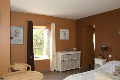a bedroom with a bed and a window at La Bastide de Venelles in Venelles
