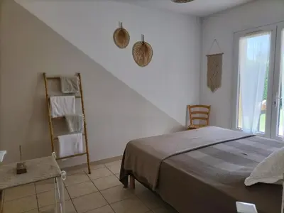 a white room with a bed and a window at Villa Zénitude in Cabannes