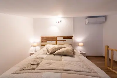 a bedroom with a large bed with two lamps at chez nico in Bédoin