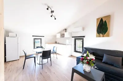 a living room with a couch and a table at chez nico in Bédoin