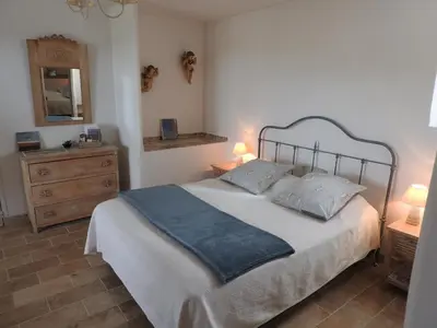 a bedroom with a large bed with two pillows at Le Mas de l'Escaillon in Saint-Saturnin-les-Apt