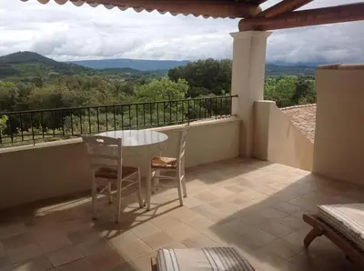 a balcony with a table and chairs and a view at Le Mas de l'Escaillon in Saint-Saturnin-les-Apt