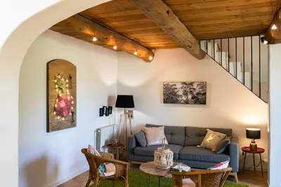 a living room with a couch and a table at Gîtes Domaine des Machottes in Grans