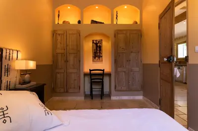 a bedroom with a bed and a desk at Gîtes Domaine des Machottes in Grans