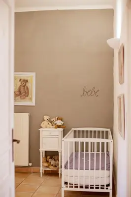 a baby room with a crib and a wall with the words better at Mas de Canfier in Robion en Luberon