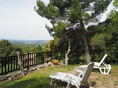 a pair of chairs and a bench in the grass at Chalet by Mont Ventoux with Stunning Views in Bédoin