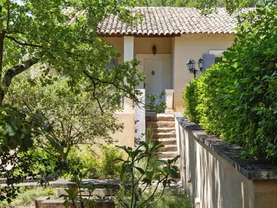 a white house with a white fence and trees at Ménerbes Home with Private Pool in Ménerbes