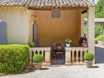 a patio of a house with a table and chairs at Ménerbes Home with Private Pool in Ménerbes