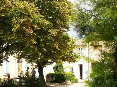 a large white house with trees in front of it at Sunny Provence Home with Terrace in Monteux
