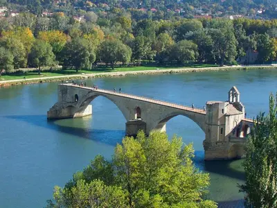 a bridge over a river with people crossing it at Sunny Provence Home with Terrace in Monteux
