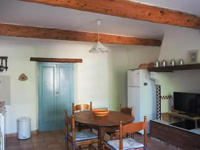 a kitchen with a table and chairs and a refrigerator at Sunny Provence Home with Terrace in Monteux