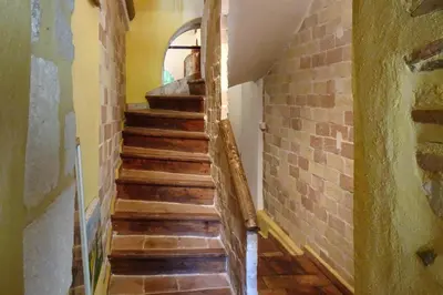 a staircase in a house with a brick wall at Cozy Noves Home with Pool Access in Noves
