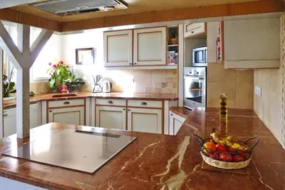 a kitchen with a bowl of fruit on a counter at Premium villa with garden and pool, Lambesc in Lambesc