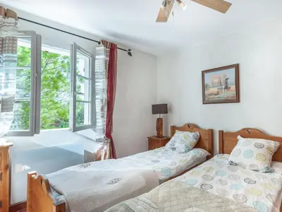 two beds in a bedroom with a window at Holiday Home Mas de L'Oulivier by Interhome in Roussillon