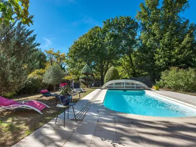 a swimming pool with a table and chairs in a yard at Holiday Home Mas de L'Oulivier by Interhome in Roussillon