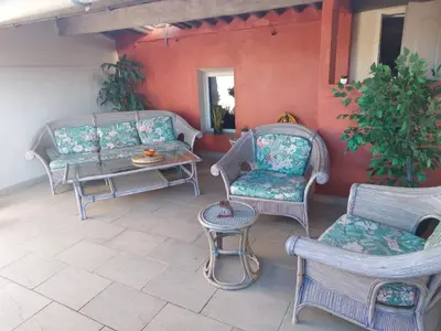 a patio with two chairs and a table at Côté Terrasse in Apt
