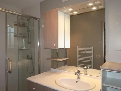 a bathroom with a sink and a shower with a mirror at Holiday Home Les Iris by Interhome in Gargas