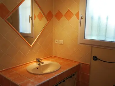 a bathroom with a sink and a mirror at Holiday Home Clos Saint Joseph by Interhome in Lagnes