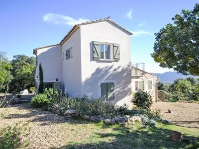 a white house with a tree in front of it at Holiday Home Les Cairnes by Interhome in Viens