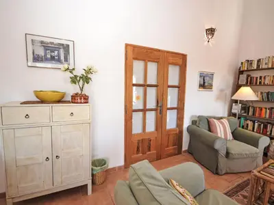 a living room with a couch and a chair at Holiday Home Les Cairnes by Interhome in Viens