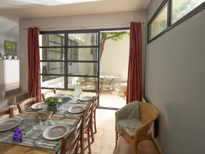 a dining room with a table and chairs at Holiday Home Villa Isabelle by Interhome in Gondonnets