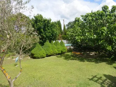 a garden with trees and bushes in a yard at Apartment Haider by Interhome in Caumont-sur-Durance