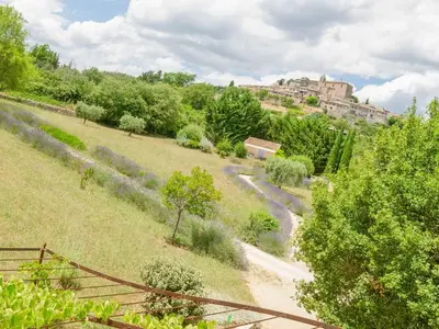 a path through a field with a castle in the background at Holiday Home Les Cotes by Interhome in Saint-Martin-de-Castillon