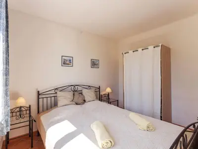 a bedroom with a large bed with white sheets and pillows at Holiday Home Les Ecureuils by Interhome in Saint-Pantaléon