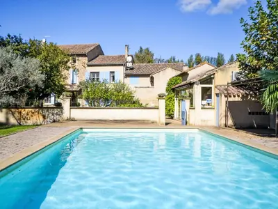 a swimming pool in front of a house at Holiday Home de la Roque by Interhome in Althen-des-Paluds