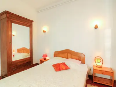 a bedroom with a bed and a large mirror at Holiday Home de la Roque by Interhome in Althen-des-Paluds