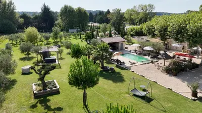 an aerial view of a resort with a pool and trees at Mas de Nonin St Rémy de Provence in Noves