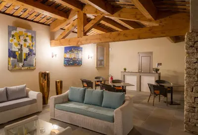 a living room with a couch and a table and chairs at Le Jas de Gordes in Gordes