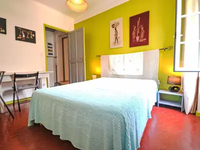 a bedroom with a bed and a yellow wall at Holiday Home La Croix du Puits by Interhome in Robion en Luberon