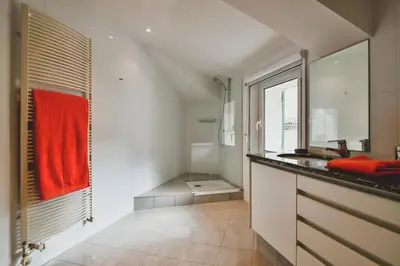 a bathroom with a sink and a red towel at Escapade en Provence in LʼIsle-sur-la-Sorgue