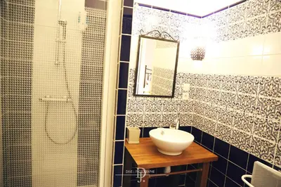 a bathroom with a sink and a shower with a mirror at Mas de la Sauline in La Roque-dʼAnthéron