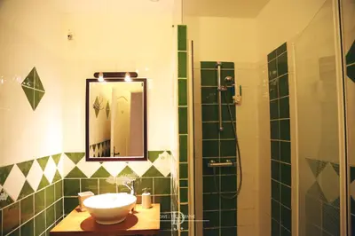 a bathroom with a sink and a shower with a mirror at Mas de la Sauline in La Roque-dʼAnthéron