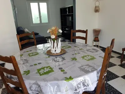a dining room table with a table cloth with flowers on it at Location maison Monteux in Monteux