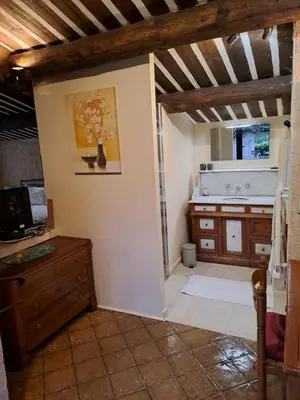 a living room with a dresser and a window at La Ferme in Saint-Marc-Jaumegarde