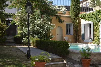a house with a swimming pool and a street light at Le Couvent in Apt