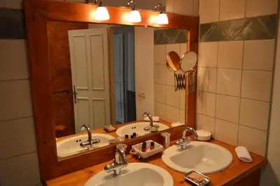 a bathroom with two sinks and a large mirror at Le Couvent in Apt