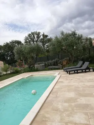 a swimming pool with a ball in the water at Sophie et Jamiel in Eyragues