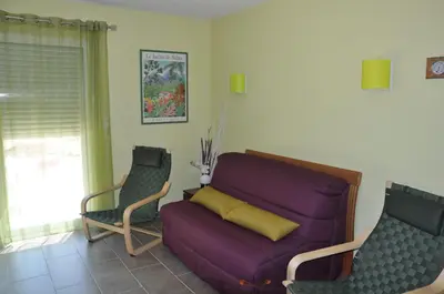 a living room with a purple couch and two chairs at Martichris in Châteauneuf-de-Gadagne