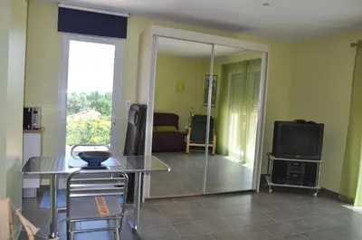 a living room with a table and a television at Martichris in Châteauneuf-de-Gadagne