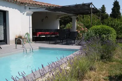 a swimming pool in the backyard of a house at charming family house with pool located at L'isle sur la sorgue - sleeps 8 in LʼIsle-sur-la-Sorgue